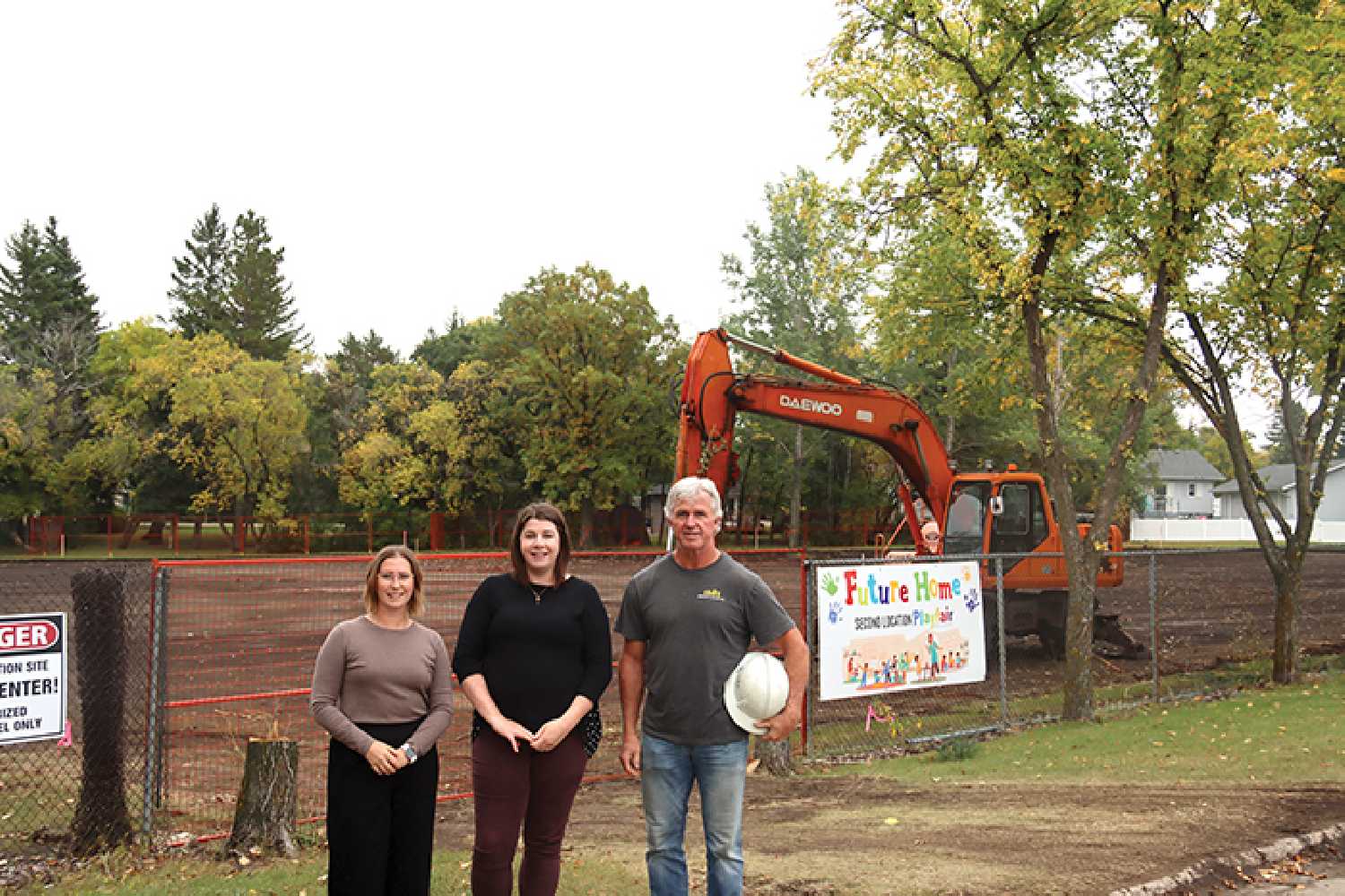Jalisa Miller and Jill Jones with Playfair Daycare, and Darren Swanson with Rococo Construction in front of the site of the new daycare under construction.